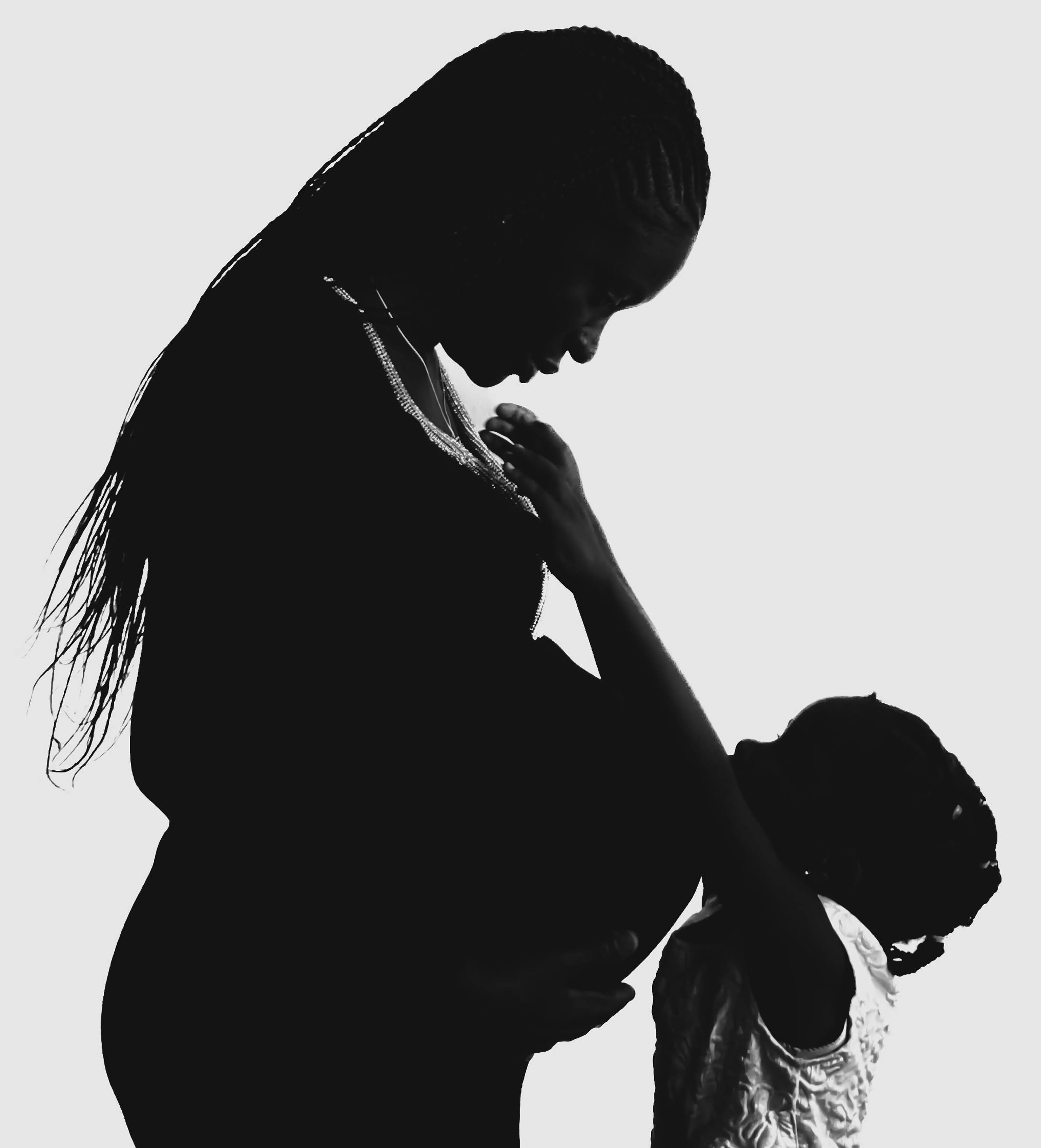 Silhouette of pregnant mother and child